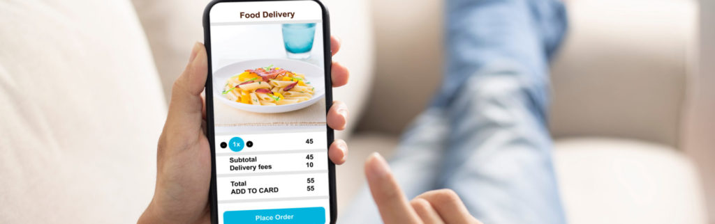 Person ordering food online using an online food ordering system set up by a restaurant